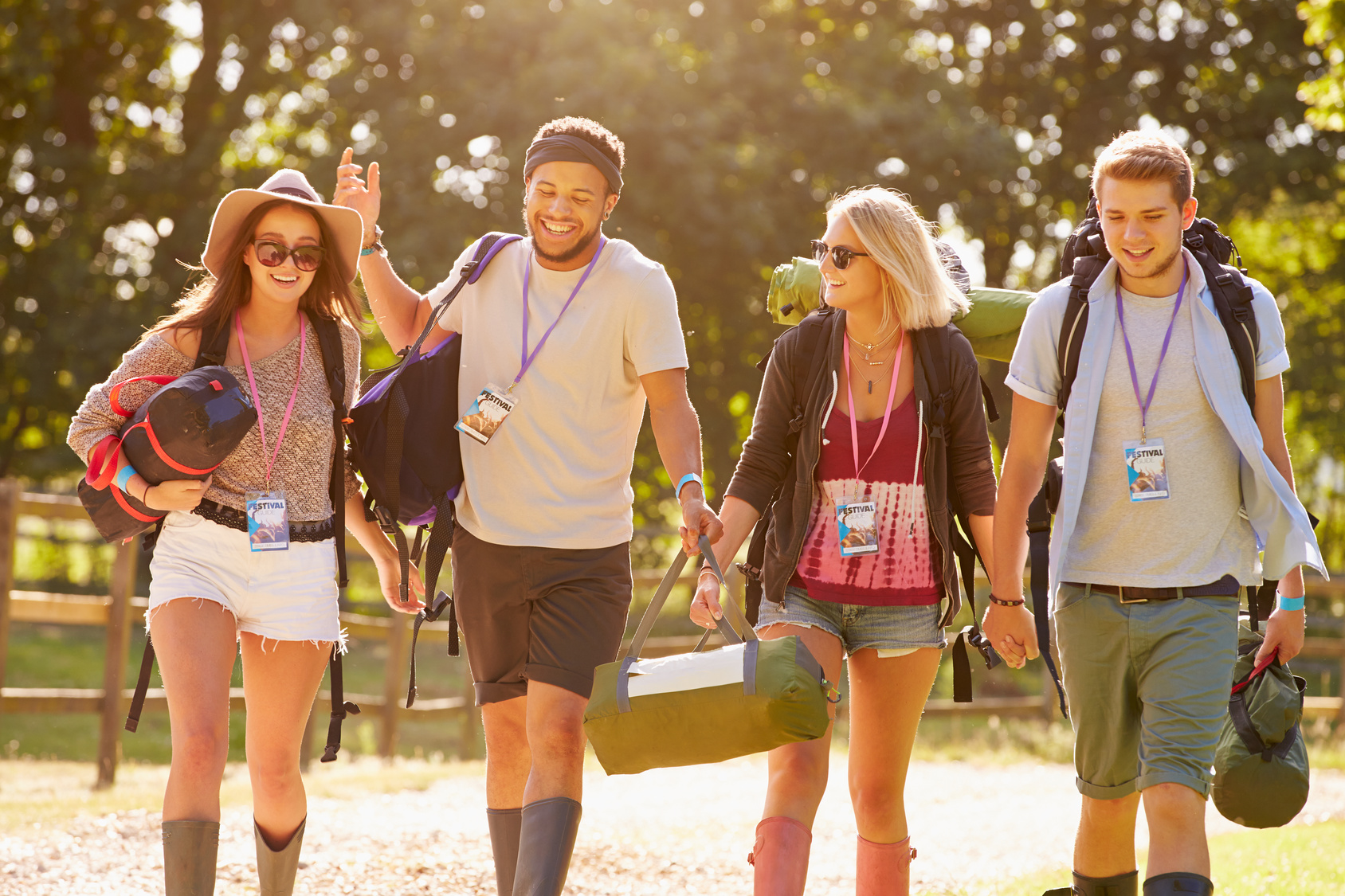 Group Of Young People Going Camping At Music Festival